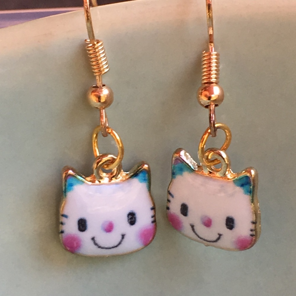 Smiling enamel cartoon cat faces